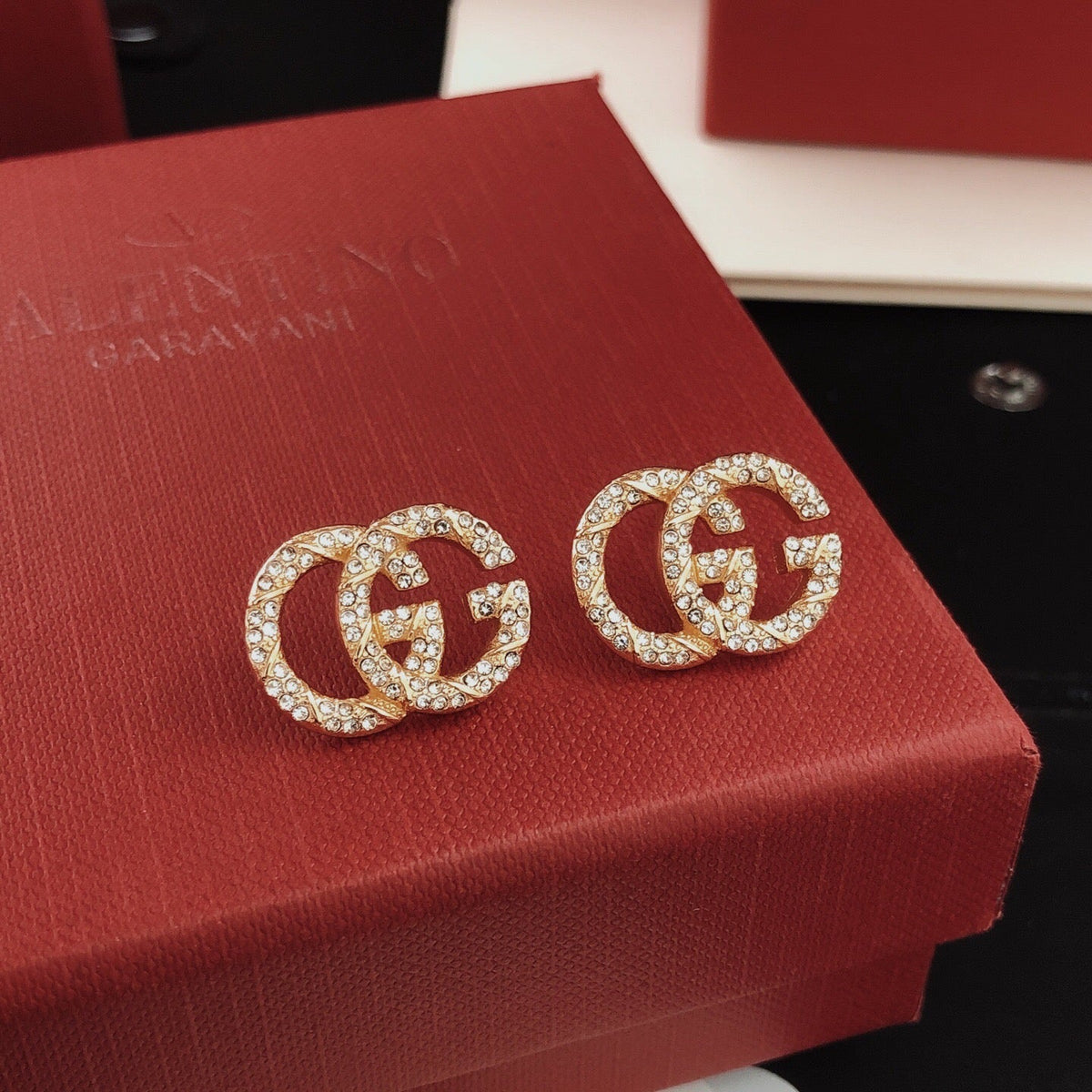 Martin Graham stud earrings in polished metal-tone – styled product view