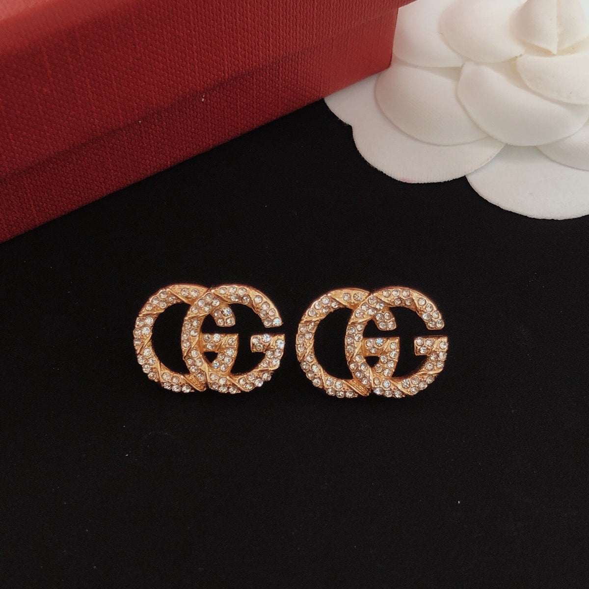 Martin Graham stud earrings in polished metal-tone – close-up detail