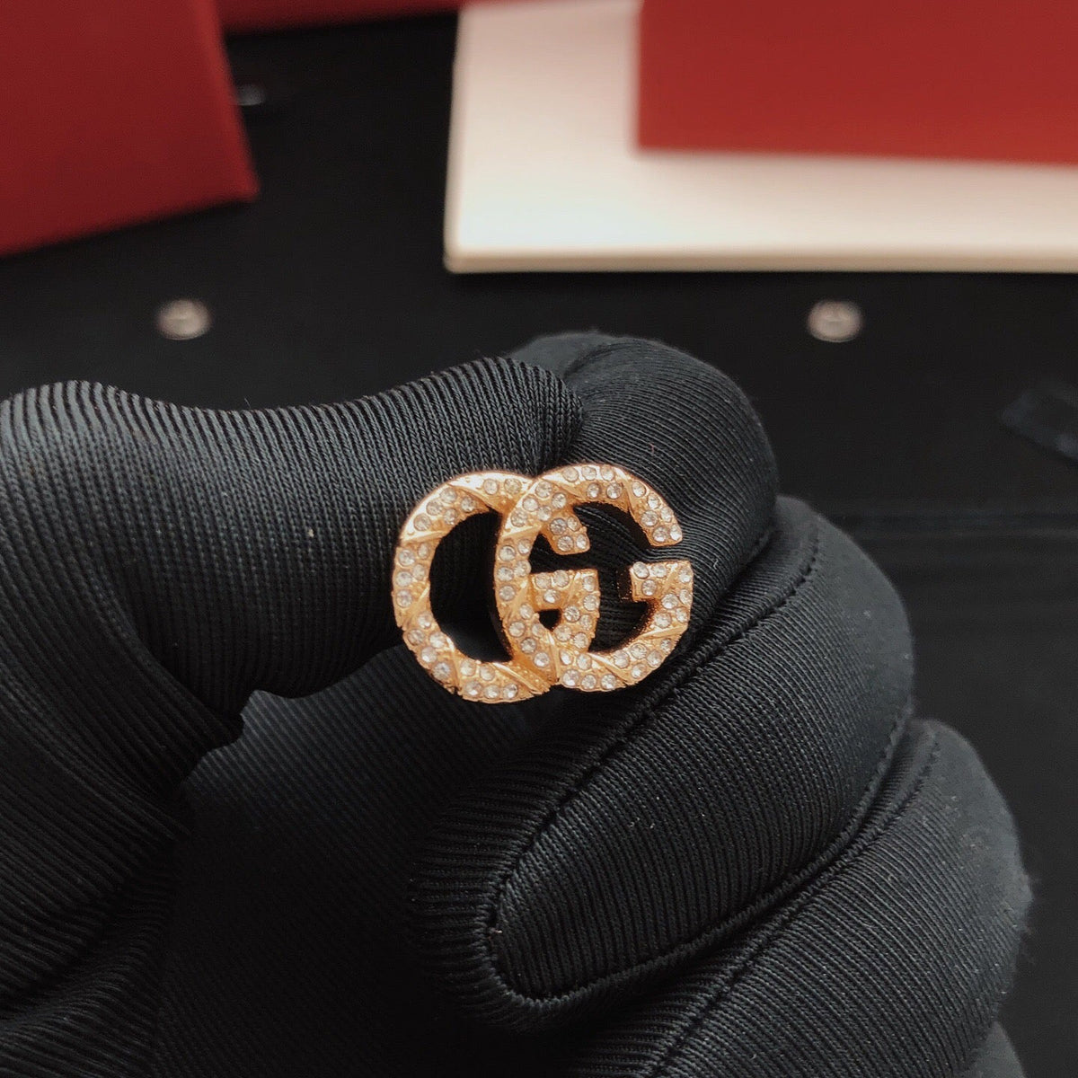 Martin Graham stud earrings in polished metal-tone – detail view