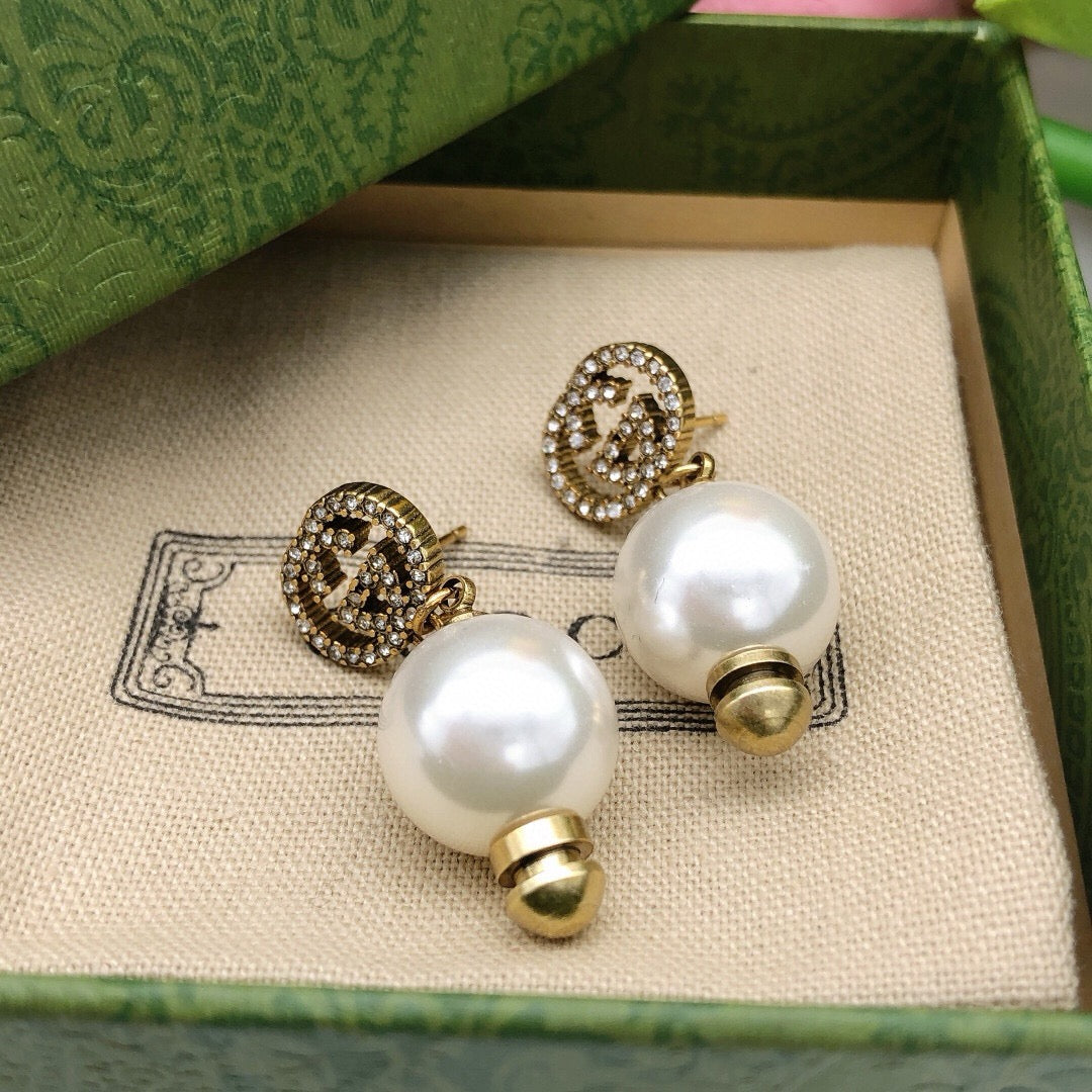 Martin Graham stud earrings in polished metal-tone – detail view