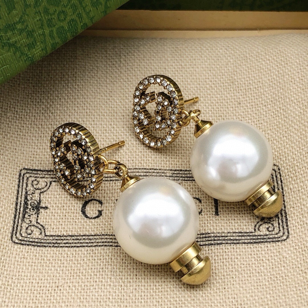 Martin Graham stud earrings in polished metal-tone – front product view
