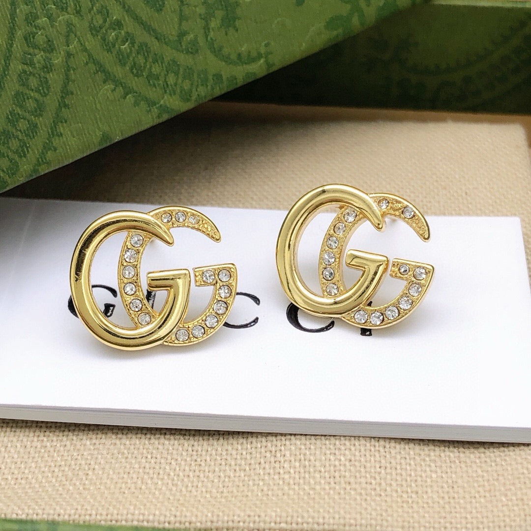 Martin Graham stud earrings in polished metal-tone – styled product view
