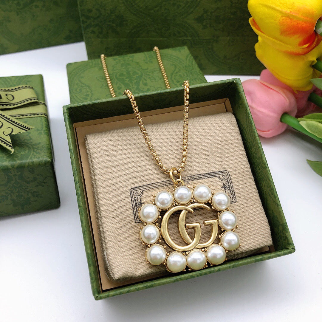 Martin Graham pendant necklace in polished metal-tone – close-up detail