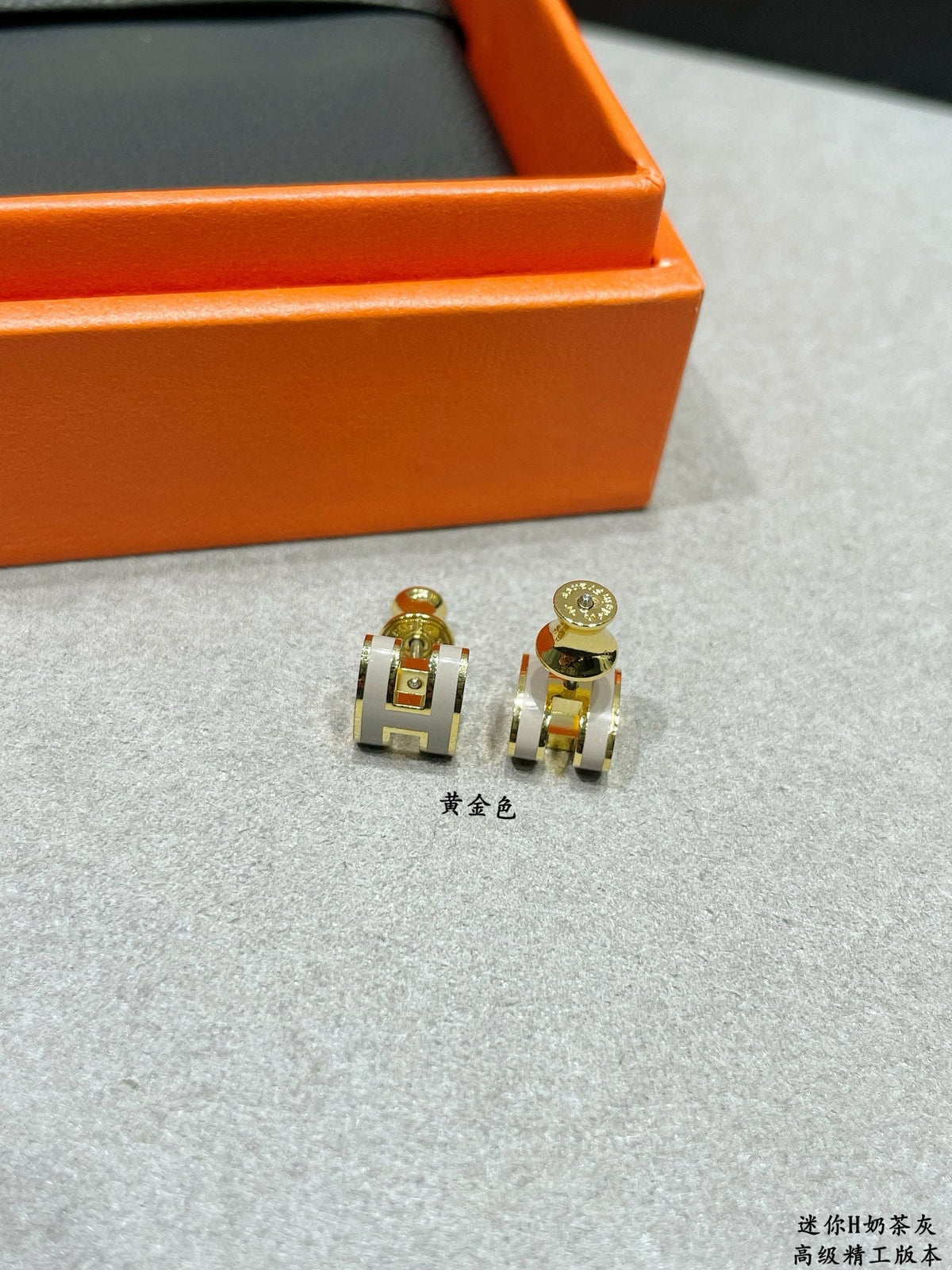 Martin Graham stud earrings in polished metal-tone – front product view