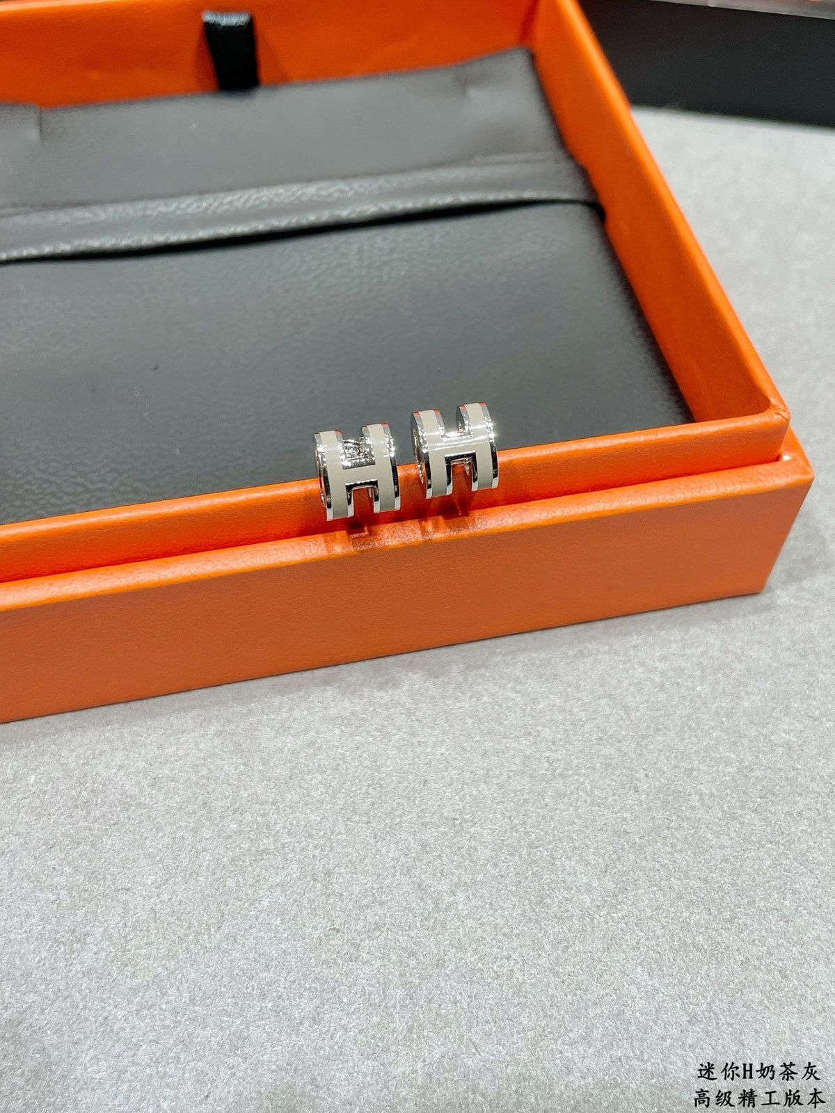 Martin Graham stud earrings in polished metal-tone – detail view