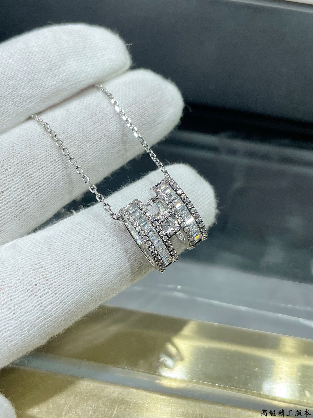 Martin Graham pendant necklace in polished metal-tone – close-up detail