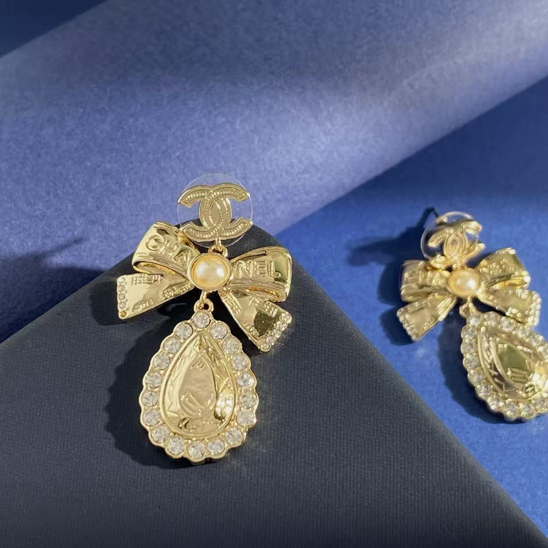 Martin Graham stud earrings in polished metal-tone – close-up detail