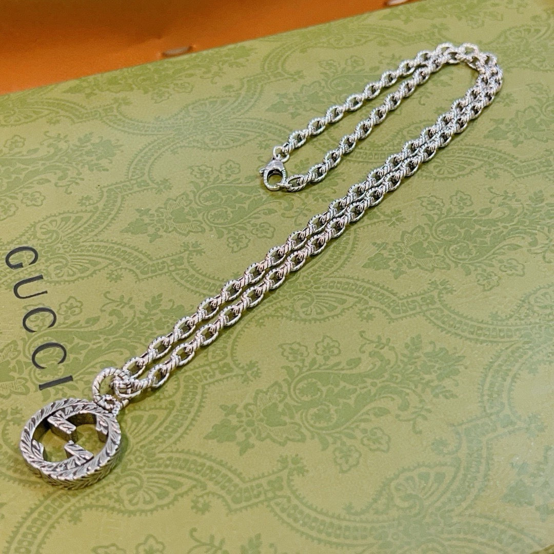 Martin Graham pendant necklace in polished metal-tone – close-up detail
