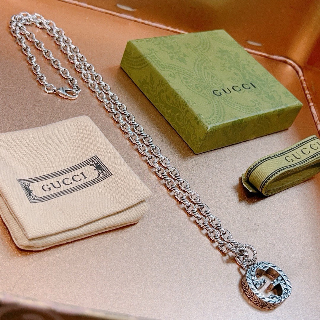 Martin Graham pendant necklace in polished metal-tone – side detail