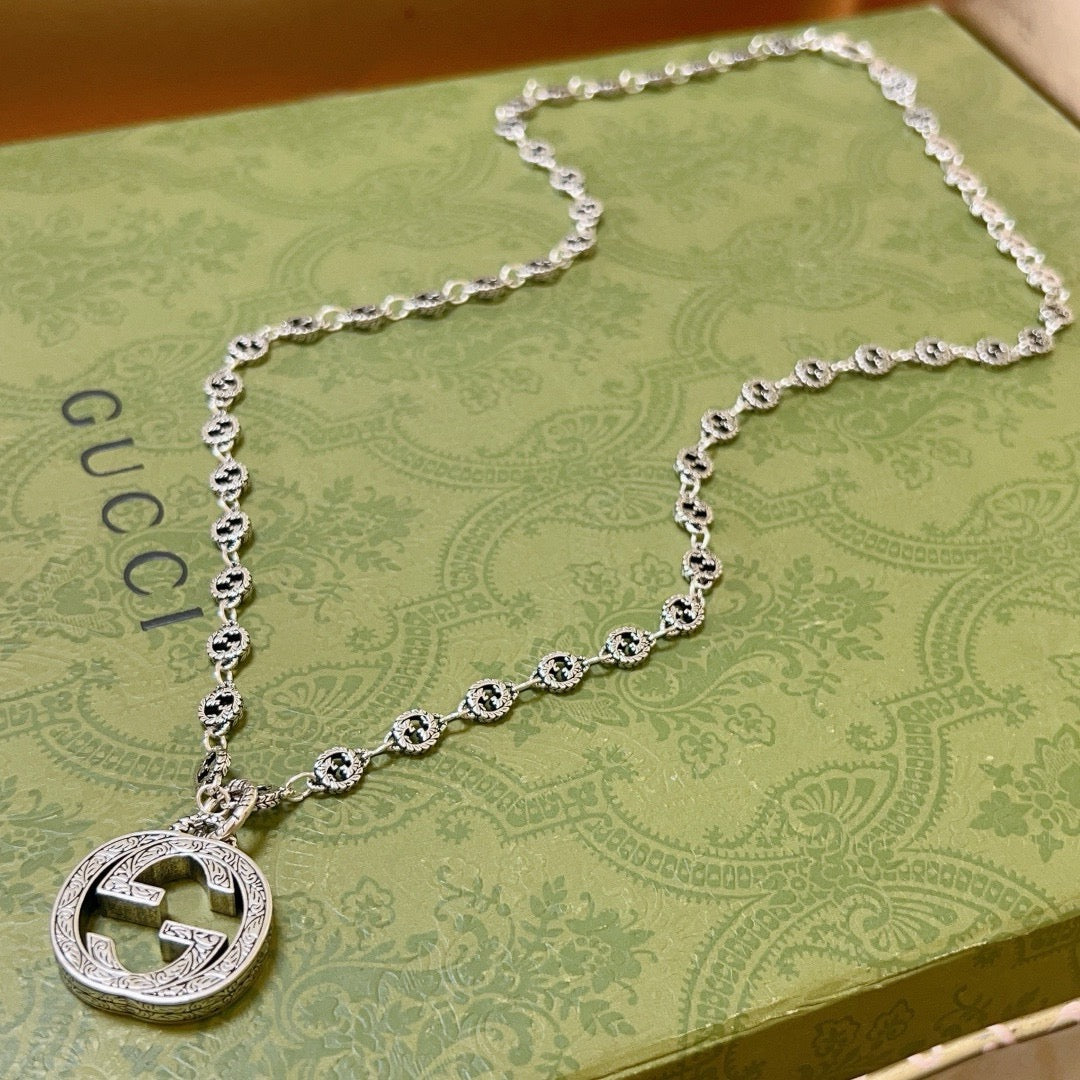 Martin Graham pendant necklace in polished metal-tone – close-up detail