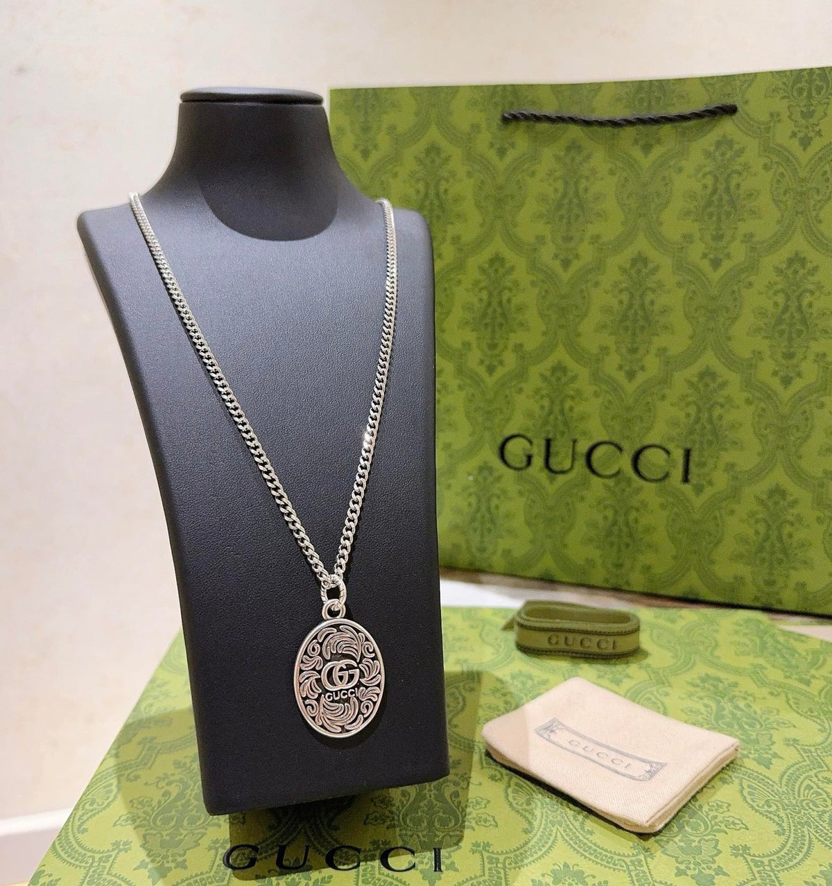 Martin Graham pendant necklace in polished metal-tone – side detail