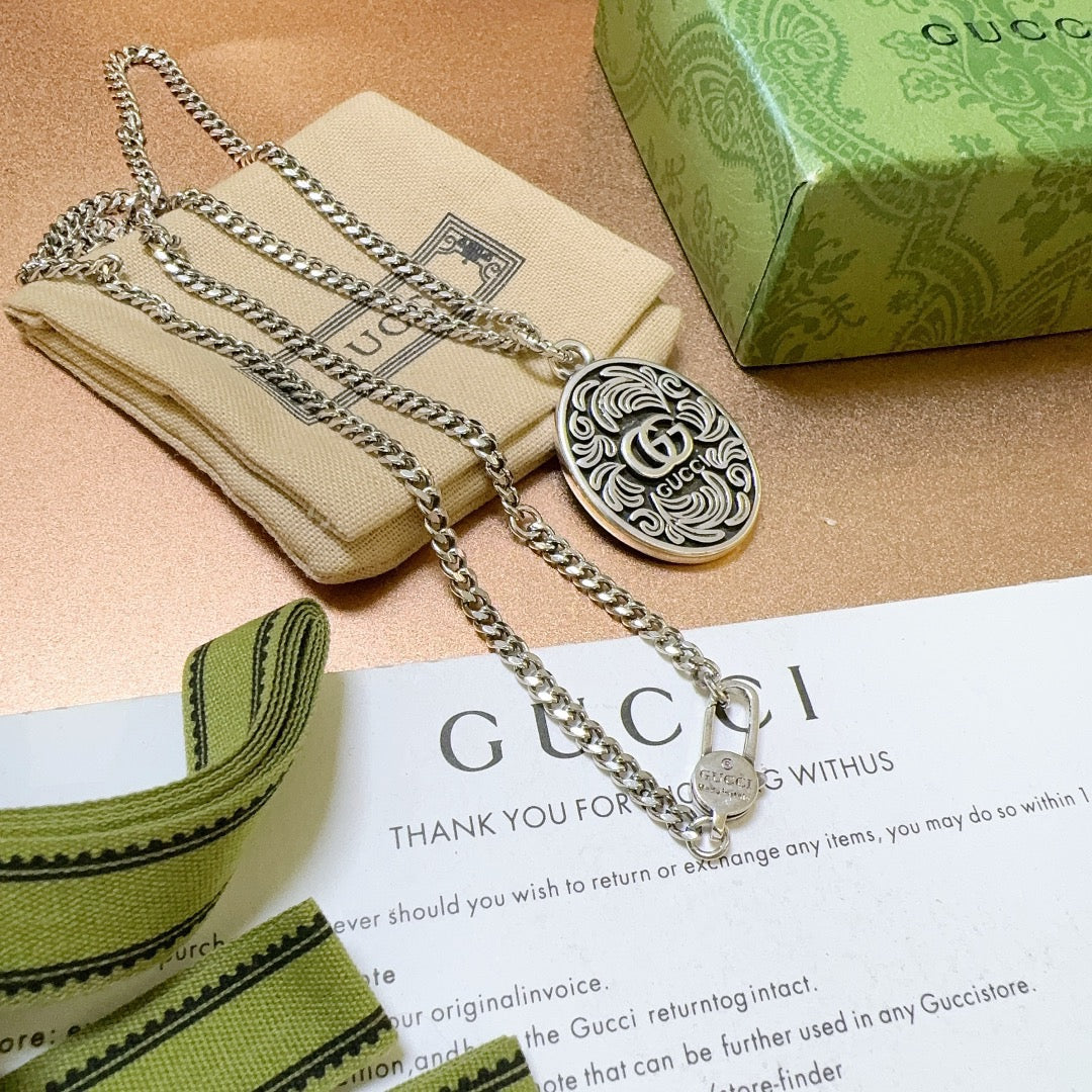 Martin Graham pendant necklace in polished metal-tone – close-up detail