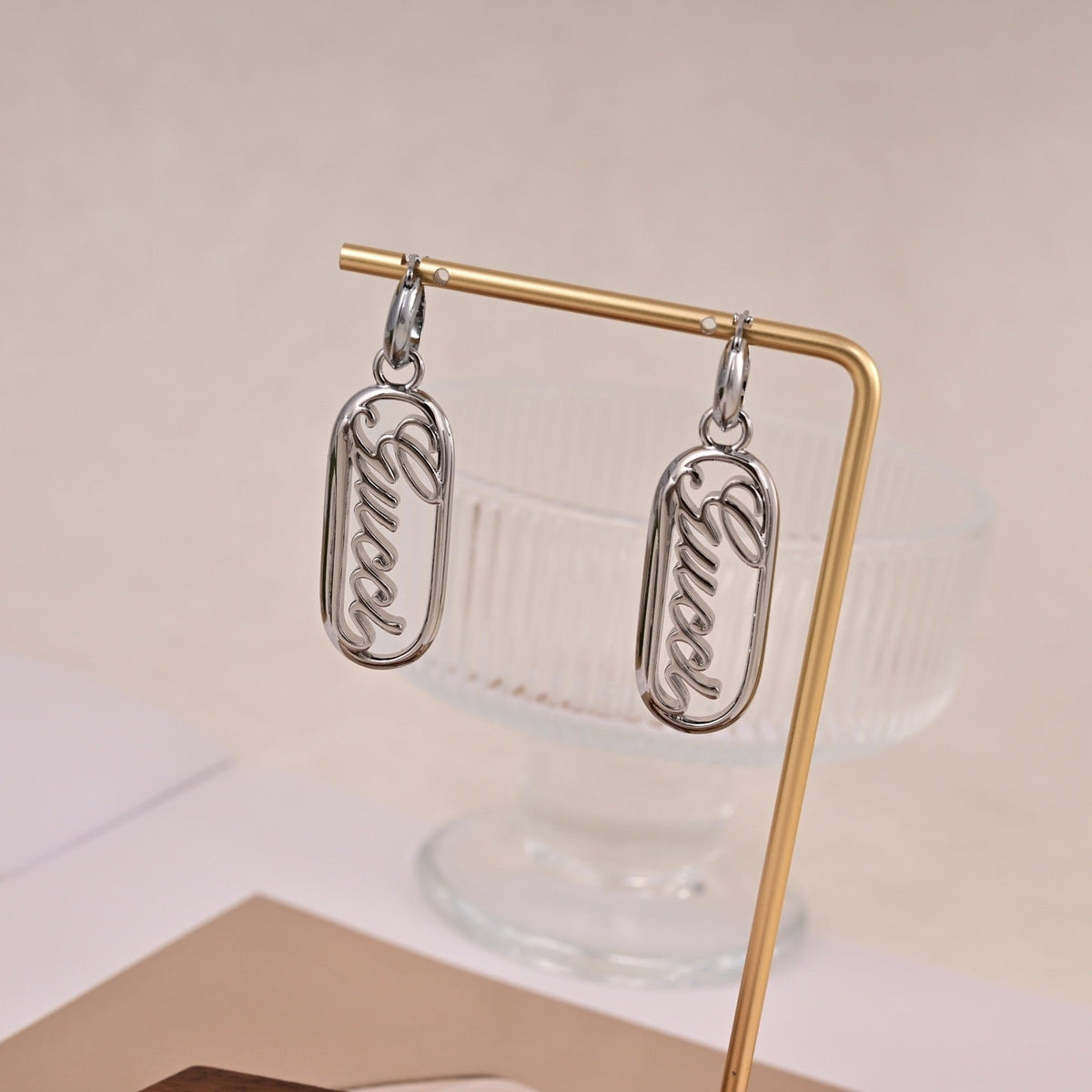 Martin Graham stud earrings in polished metal-tone – close-up detail