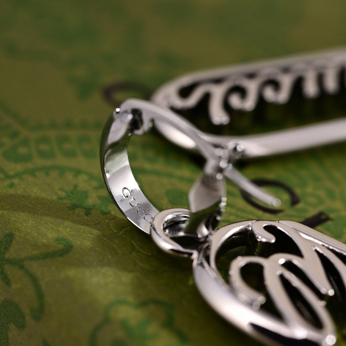 Martin Graham stud earrings in polished metal-tone – detail view