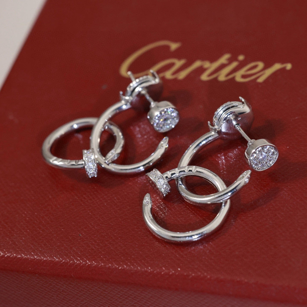 Martin Graham stud earrings in polished metal-tone – detail view