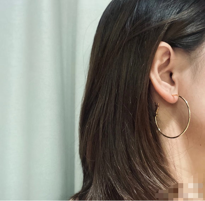 Martin Graham stud earrings in polished metal-tone – detail view