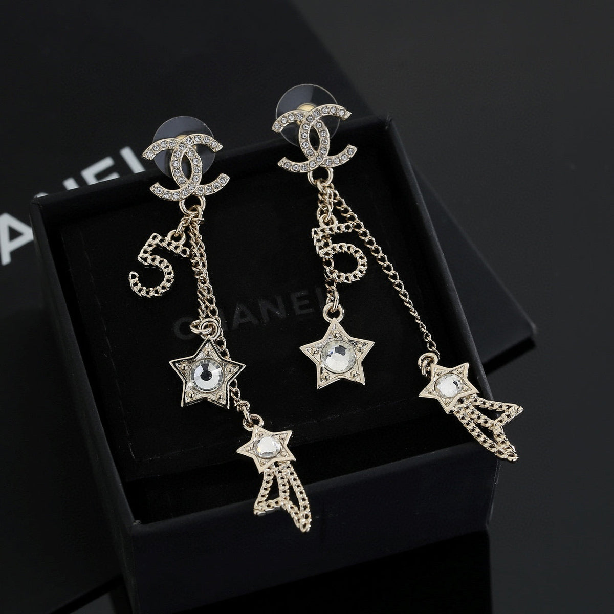 Martin Graham stud earrings in polished metal-tone – close-up detail