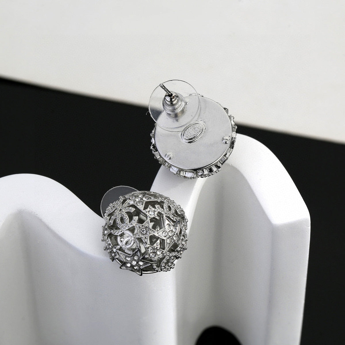 Martin Graham stud earrings in polished metal-tone – close-up detail