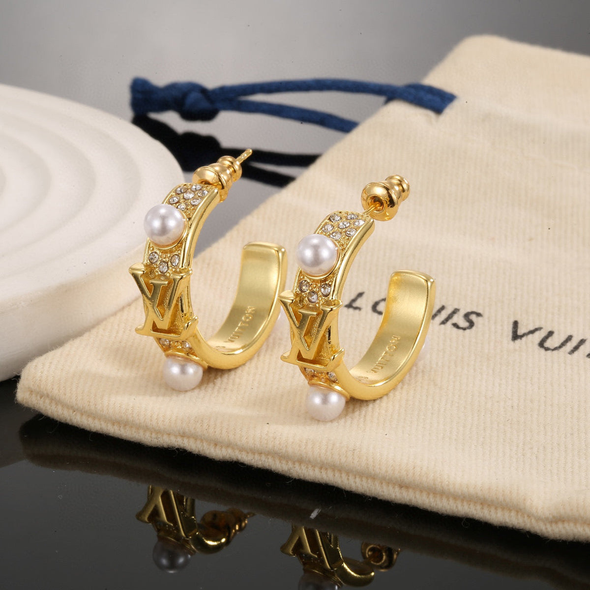 Martin Graham stud earrings in polished metal-tone – front product view