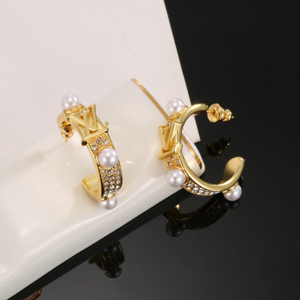 Martin Graham stud earrings in polished metal-tone – detail view