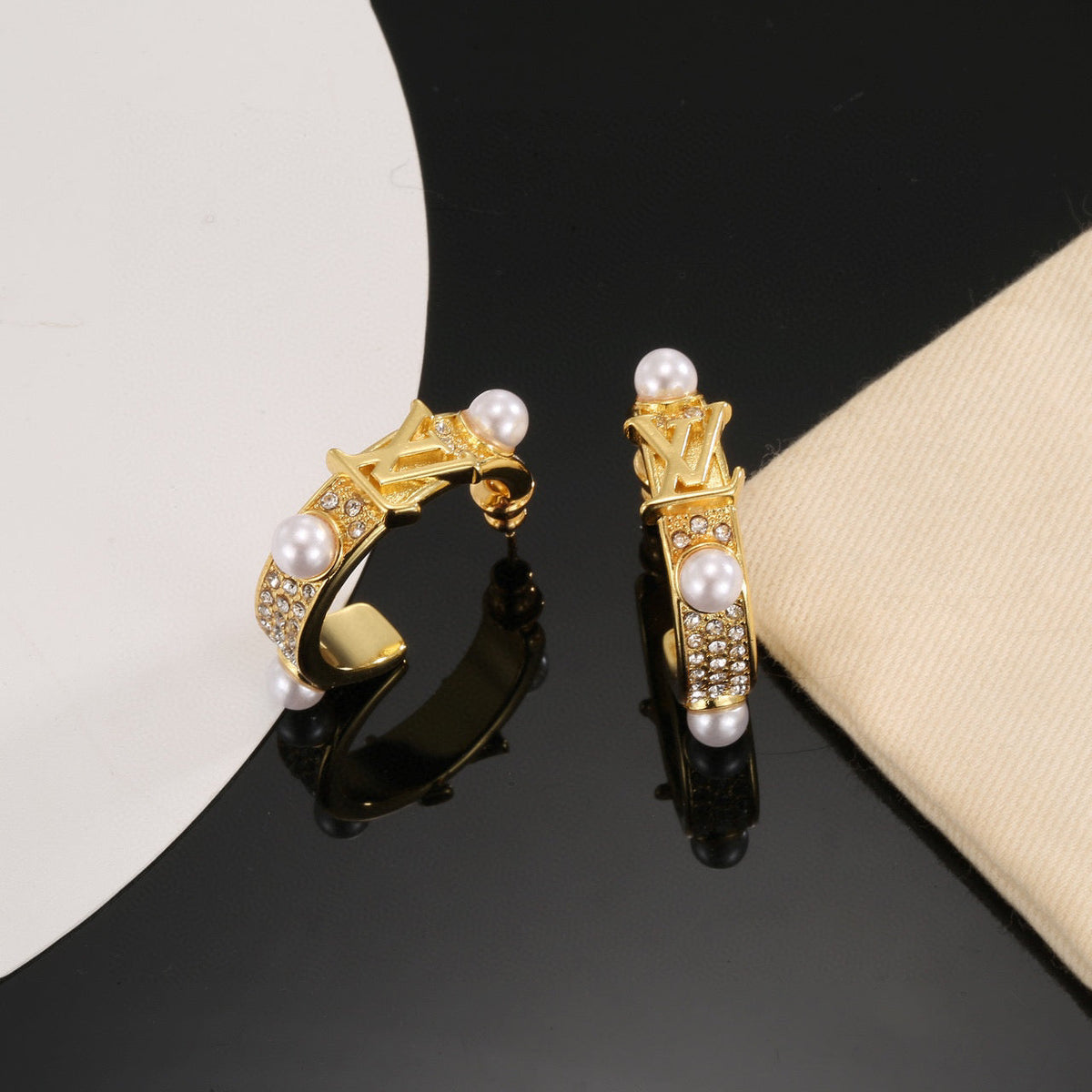 Martin Graham stud earrings in polished metal-tone – side detail