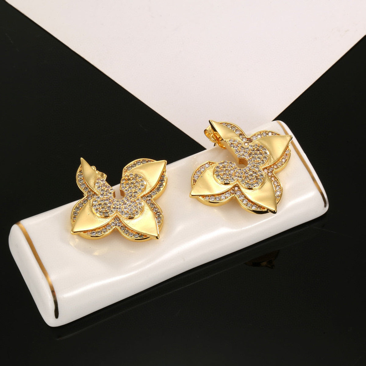 Martin Graham stud earrings in polished metal-tone – front product view