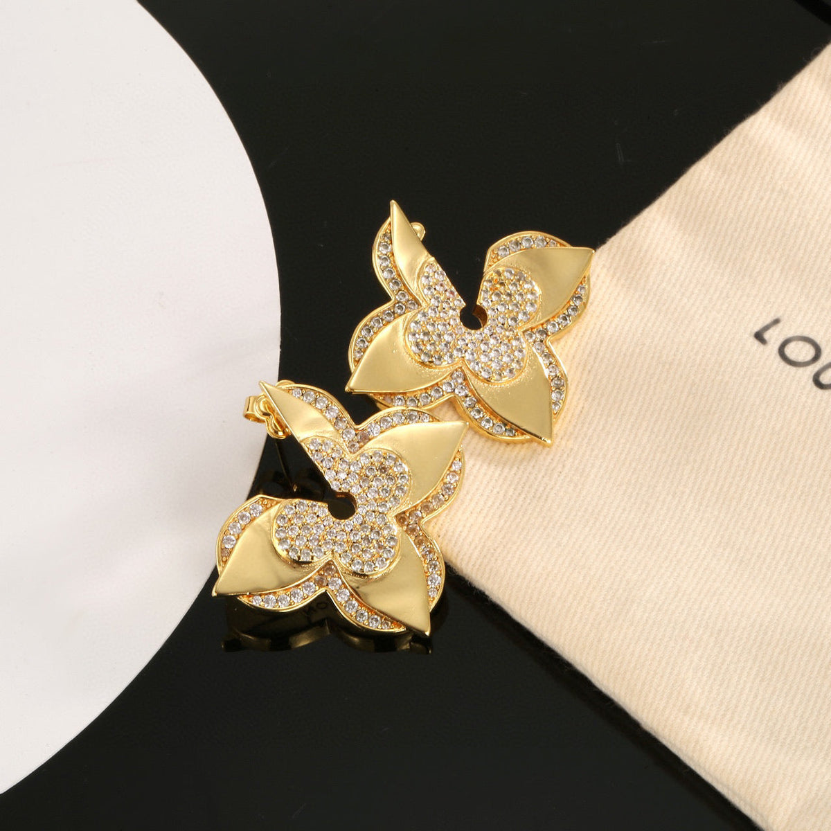 Martin Graham stud earrings in polished metal-tone – detail view