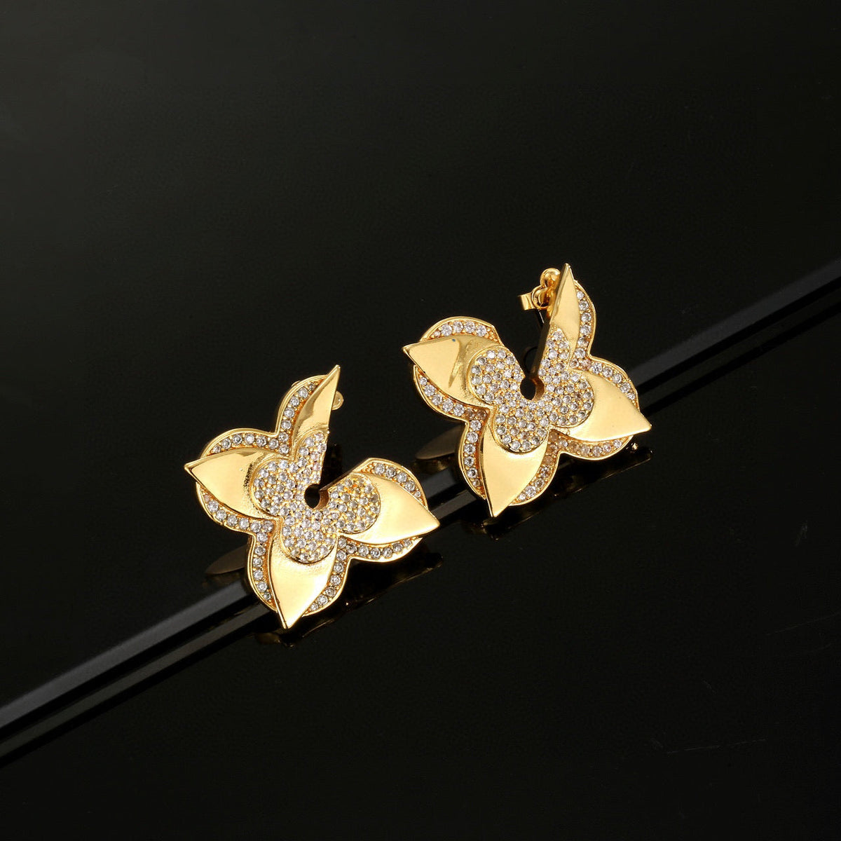 Martin Graham stud earrings in polished metal-tone – close-up detail