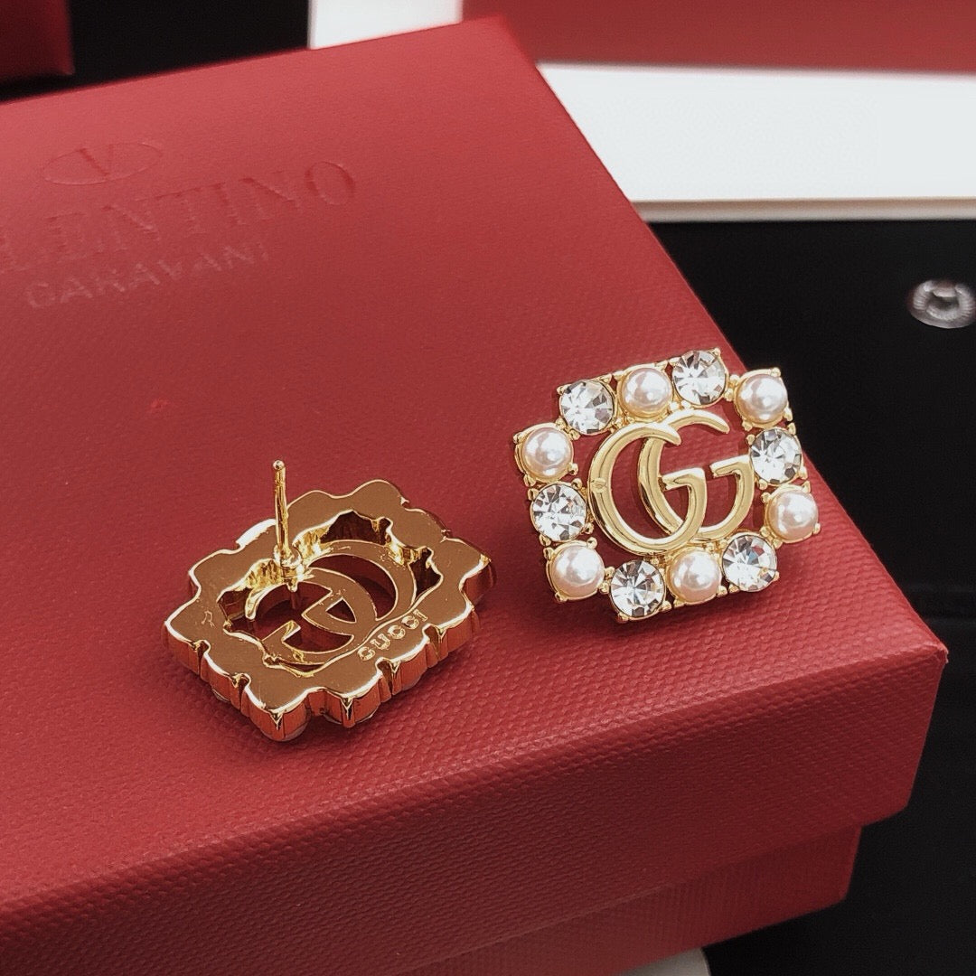 Martin Graham stud earrings in polished metal-tone – styled product view
