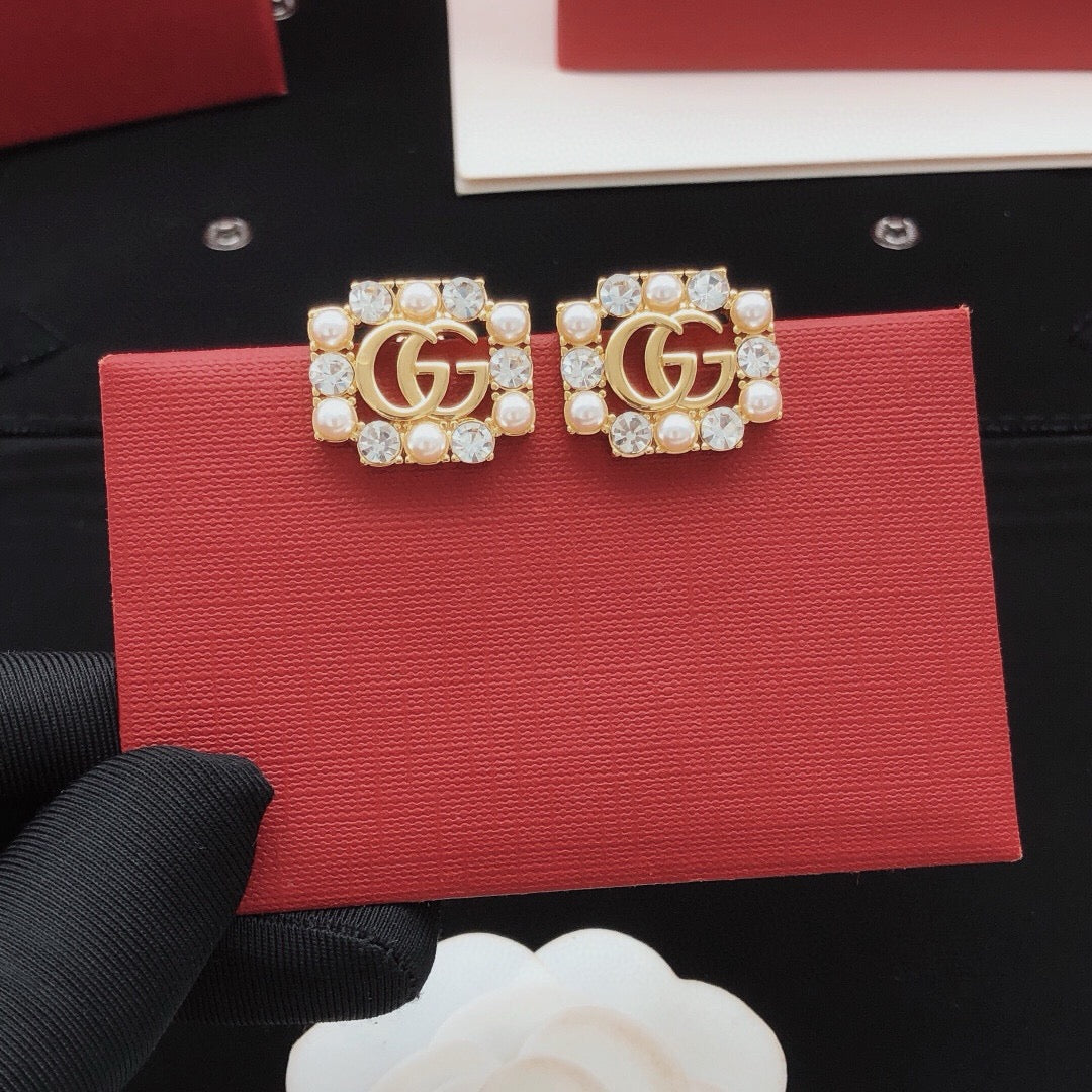 Martin Graham stud earrings in polished metal-tone – detail view