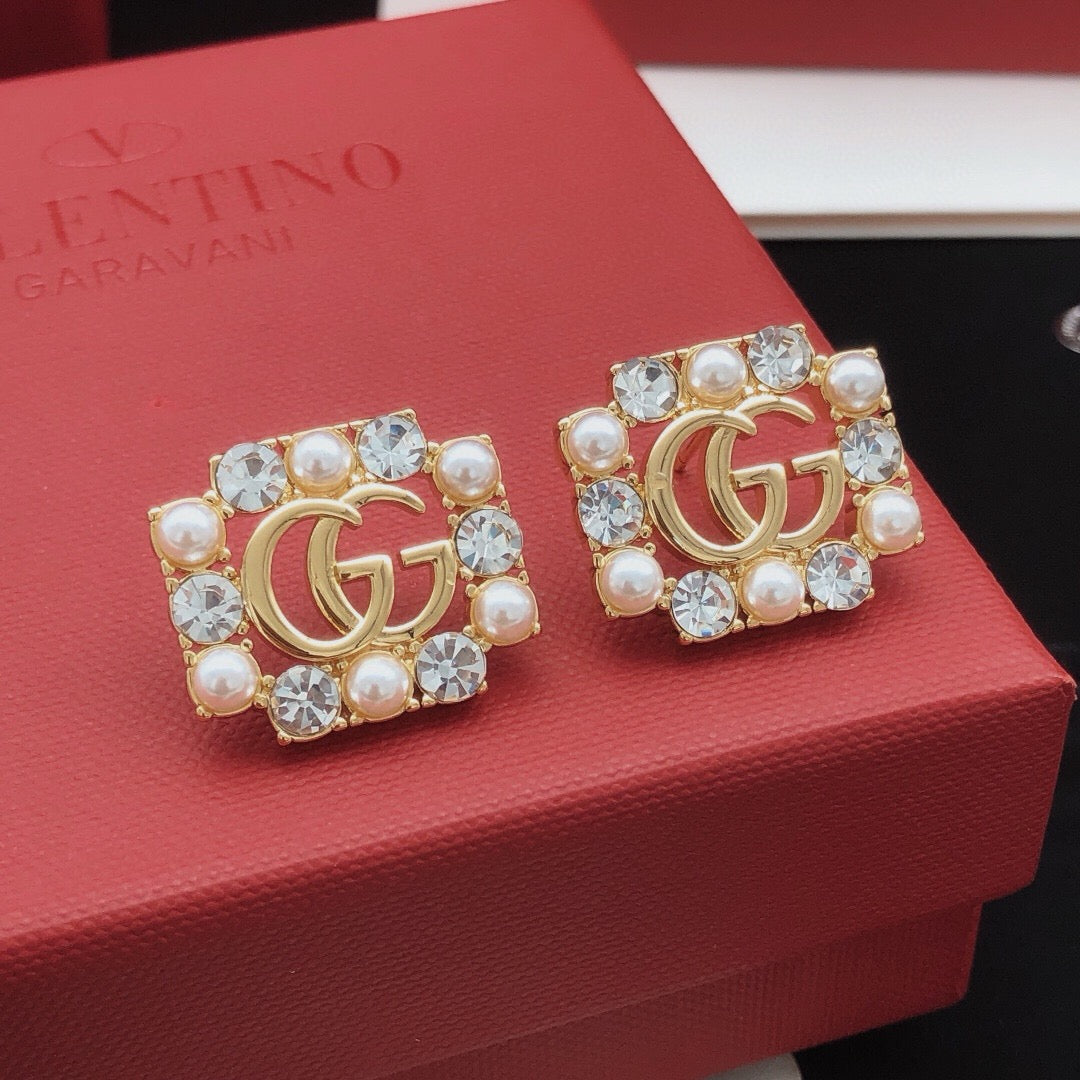 Martin Graham stud earrings in polished metal-tone – close-up detail