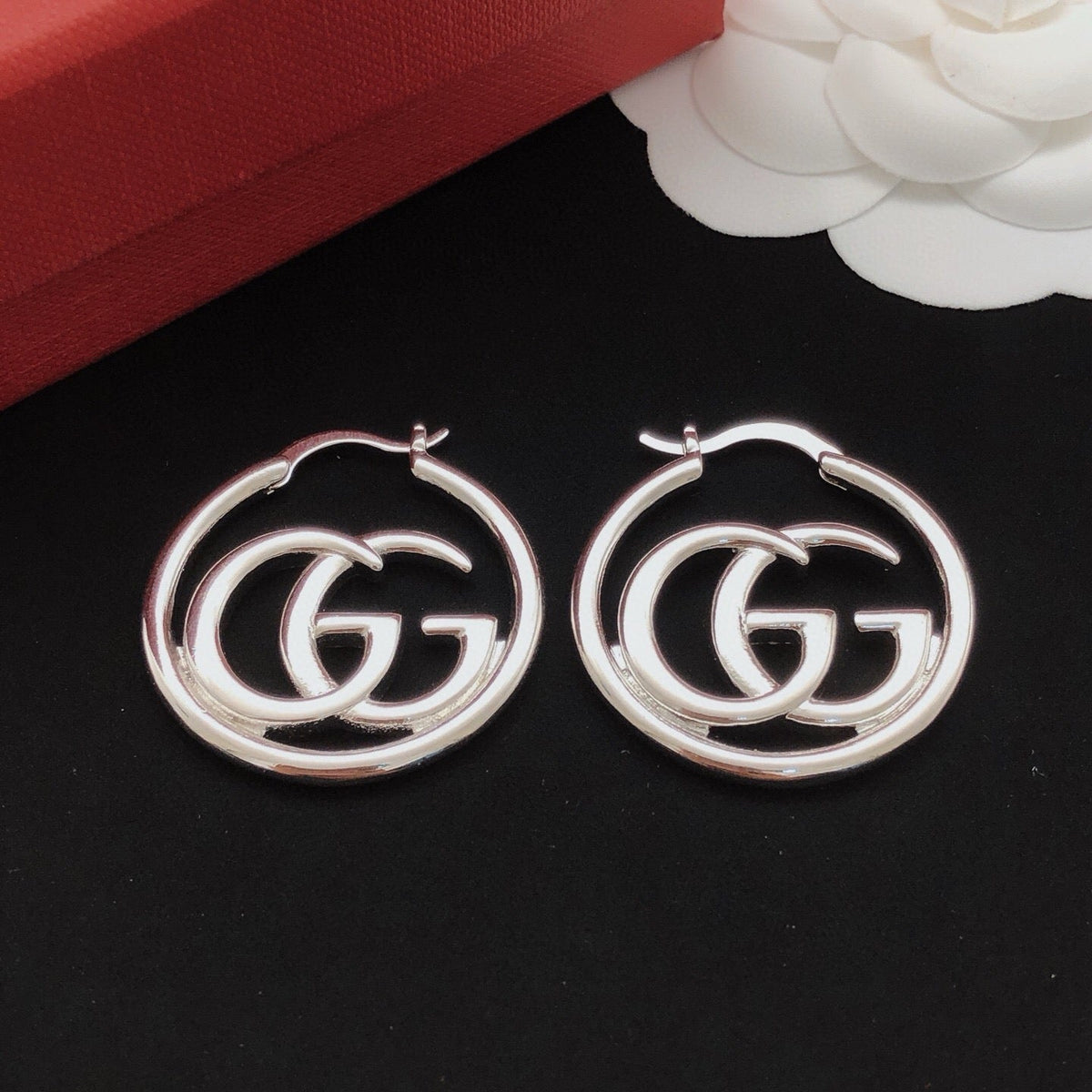 Martin Graham stud earrings in polished metal-tone – close-up detail