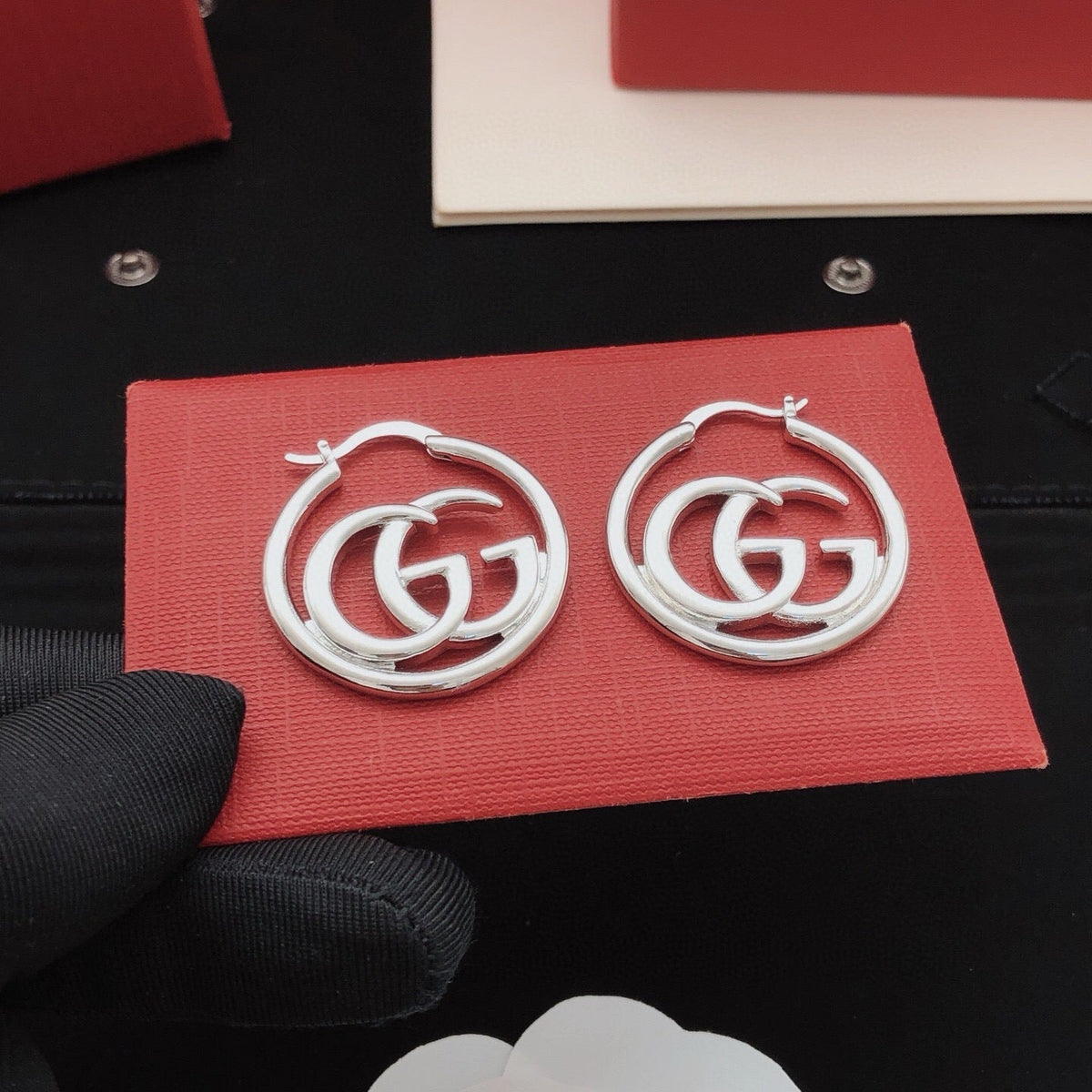 Martin Graham stud earrings in polished metal-tone – styled product view