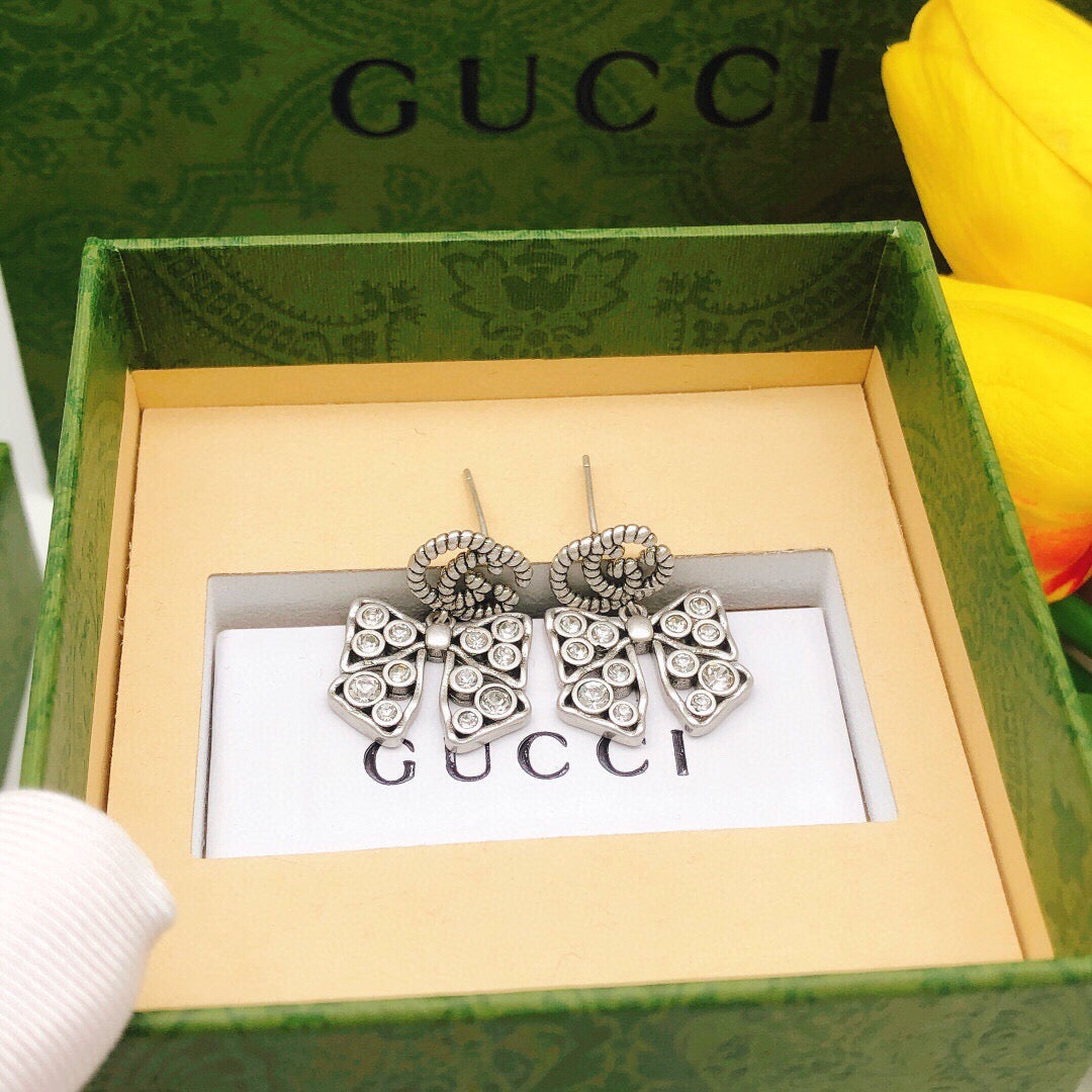 Martin Graham earrings in polished metal-tone – close-up detail