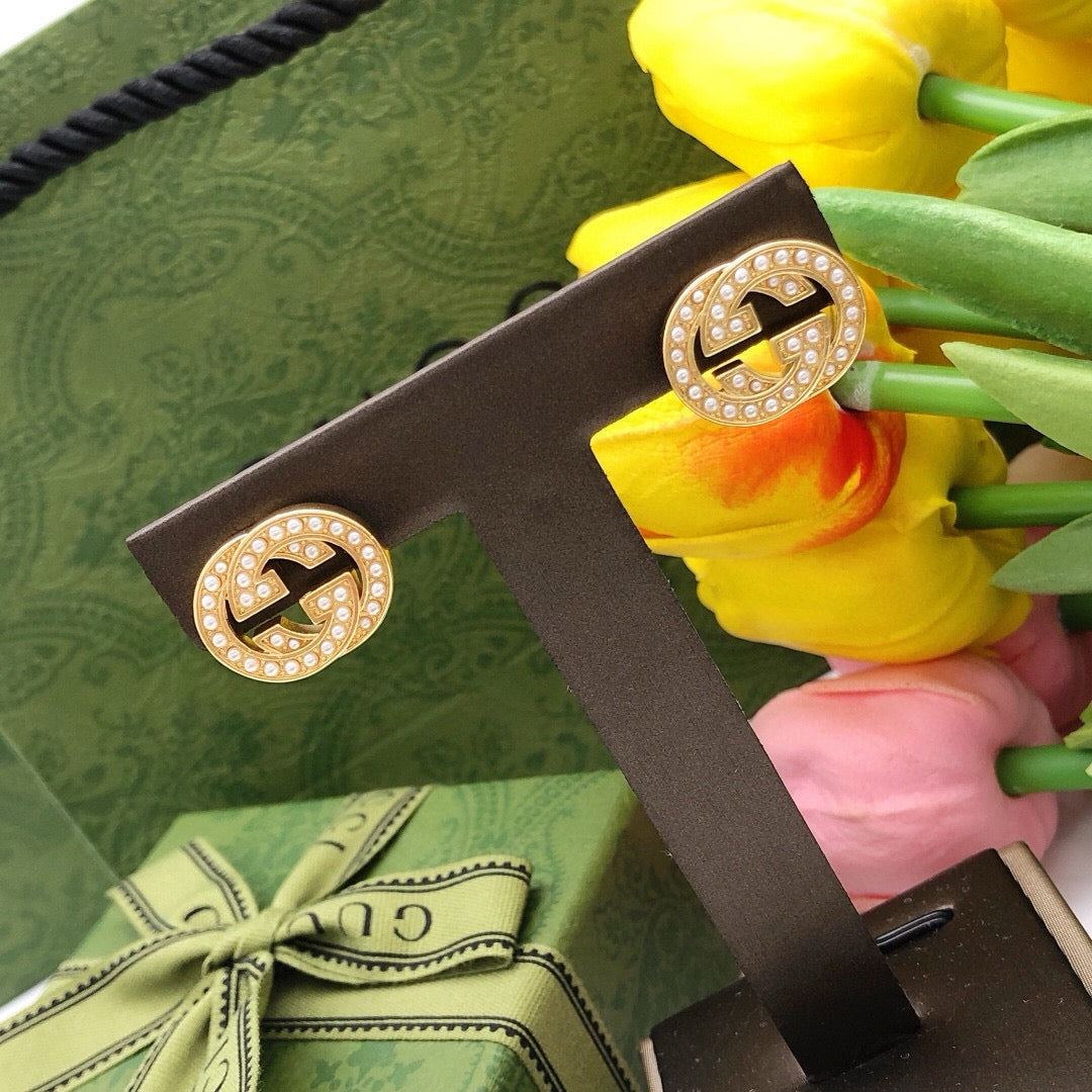 Martin Graham stud earrings in polished metal-tone – close-up detail