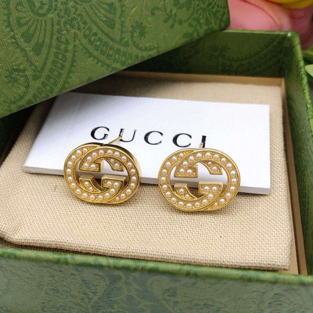 Martin Graham stud earrings in polished metal-tone – styled product view