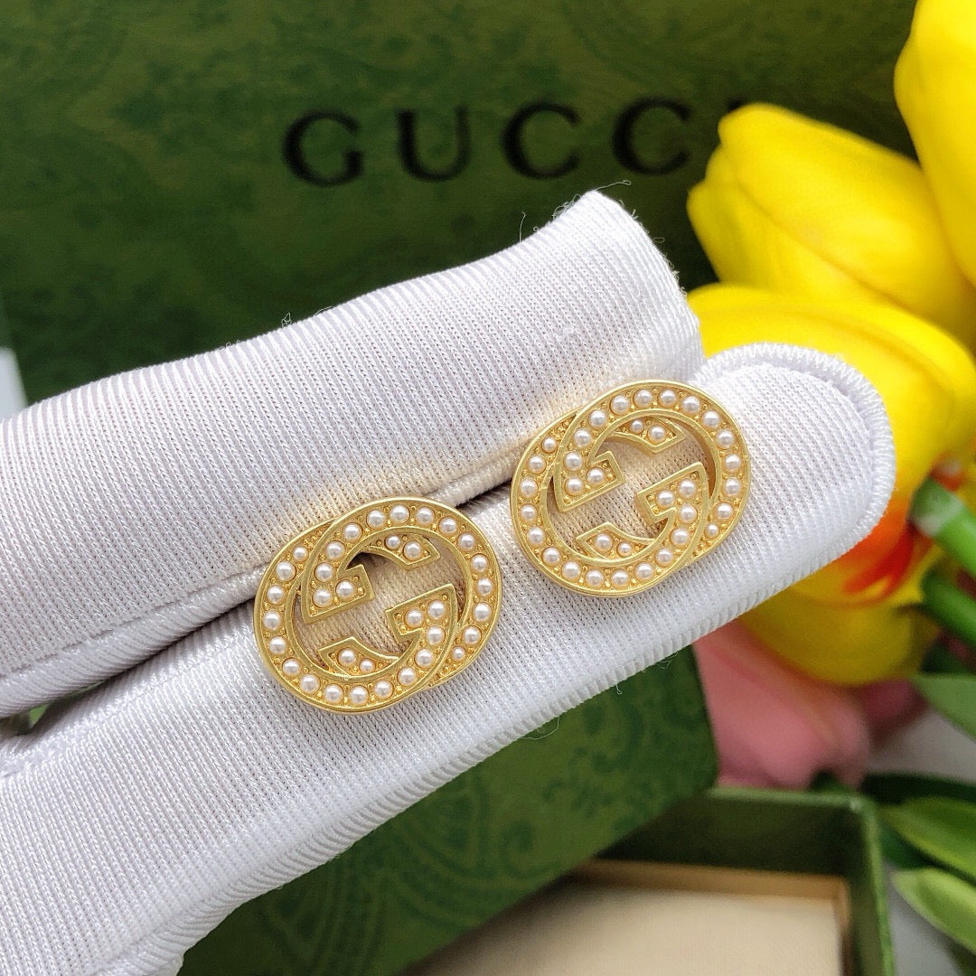 Martin Graham stud earrings in polished metal-tone – detail view