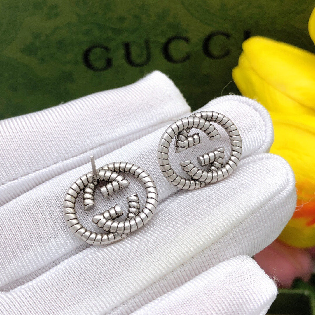Martin Graham stud earrings in polished metal-tone – front product view