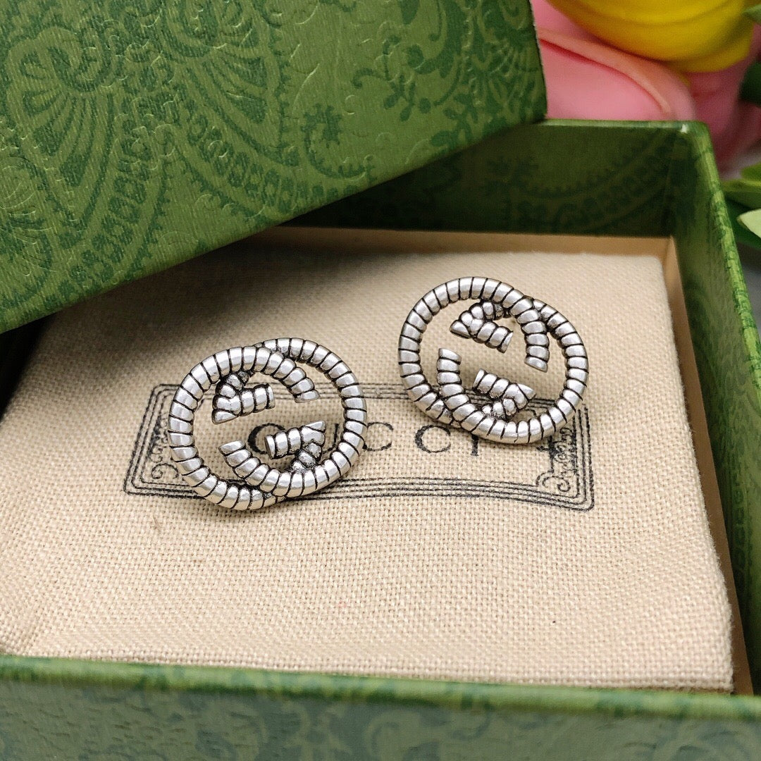 Martin Graham stud earrings in polished metal-tone – side detail