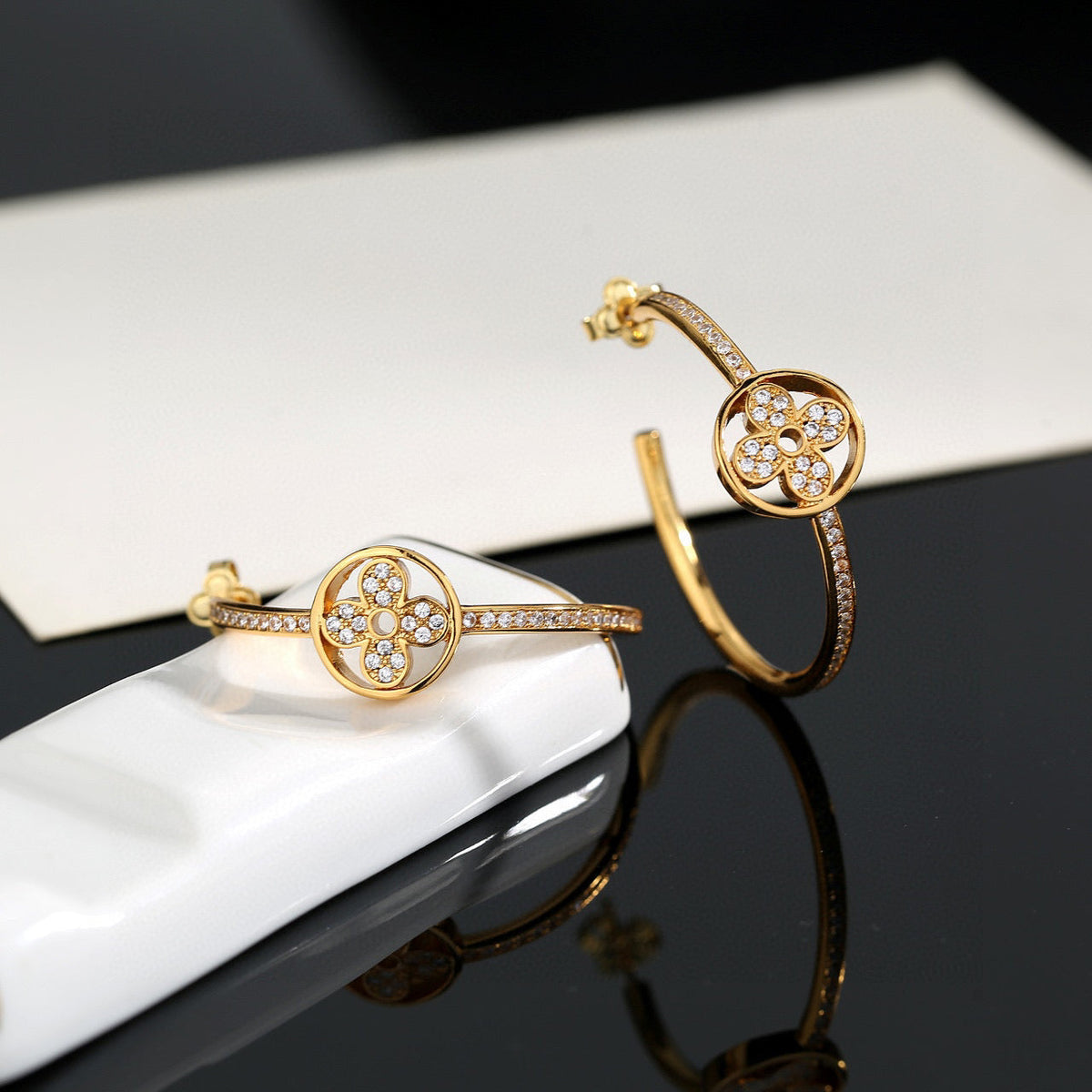 Martin Graham stud earrings in polished metal-tone – front product view