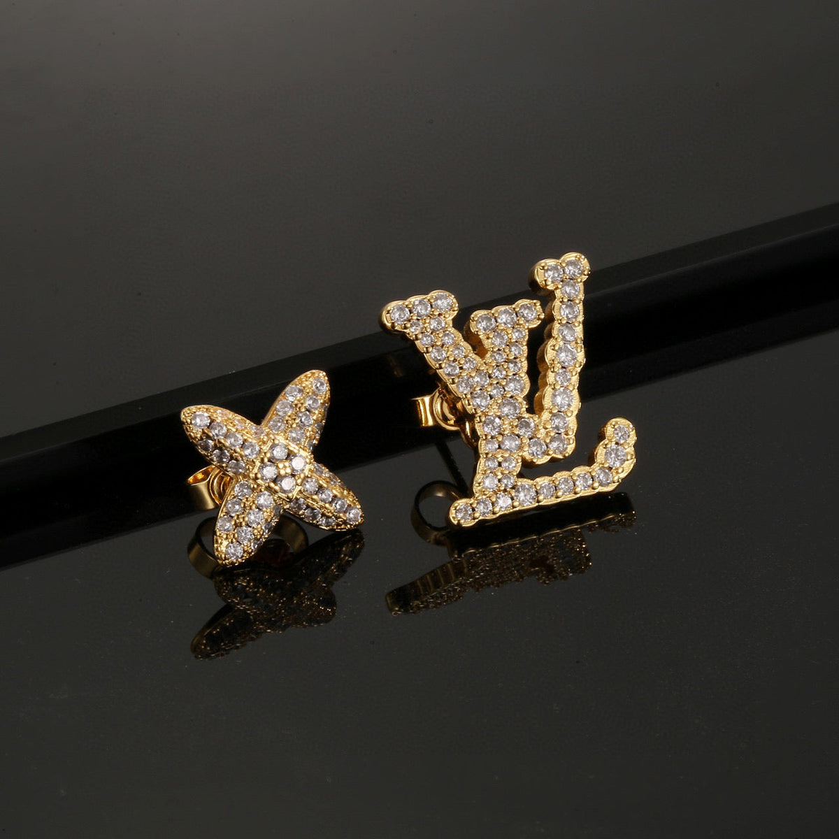 Martin Graham stud earrings in polished metal-tone – detail view