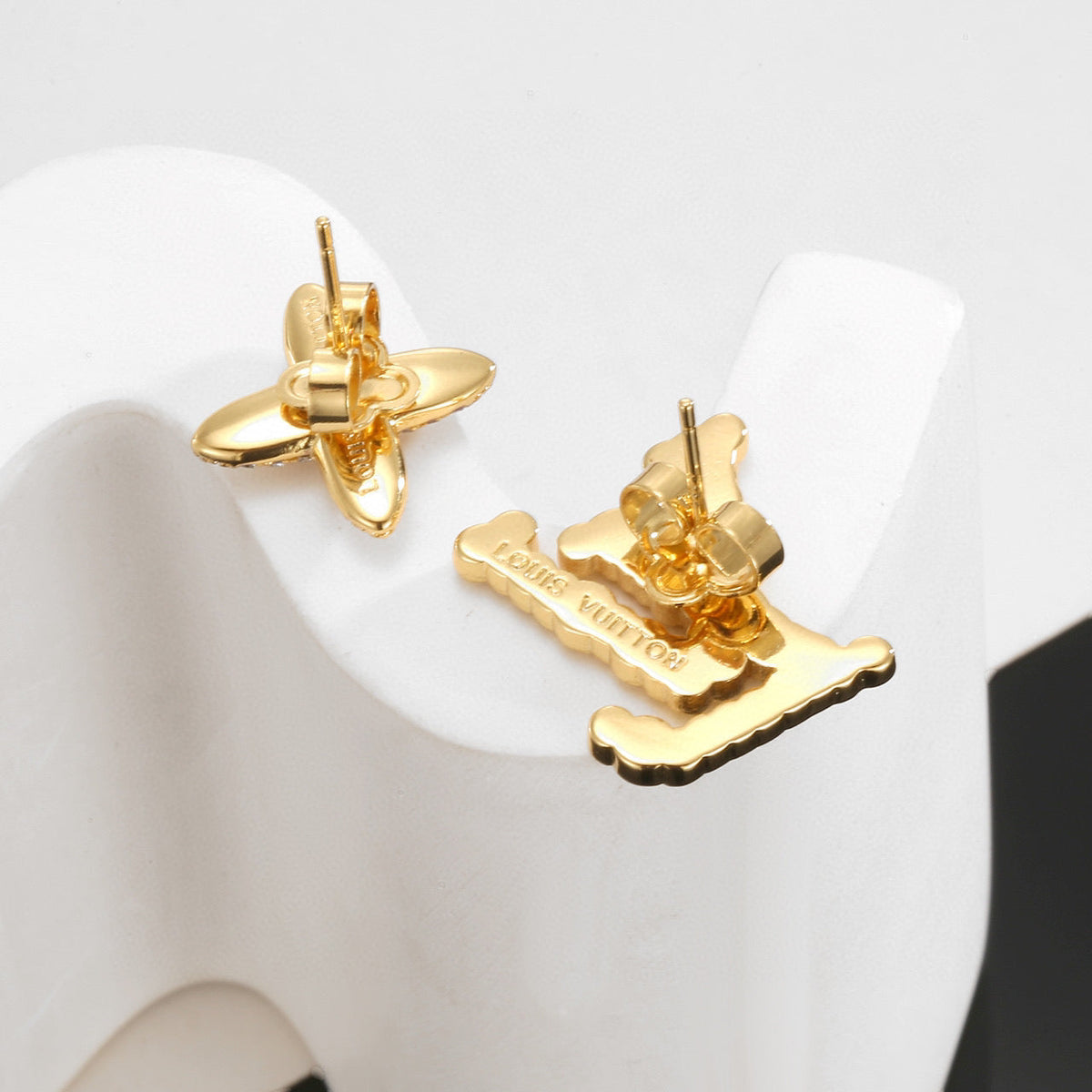 Martin Graham stud earrings in polished metal-tone – close-up detail