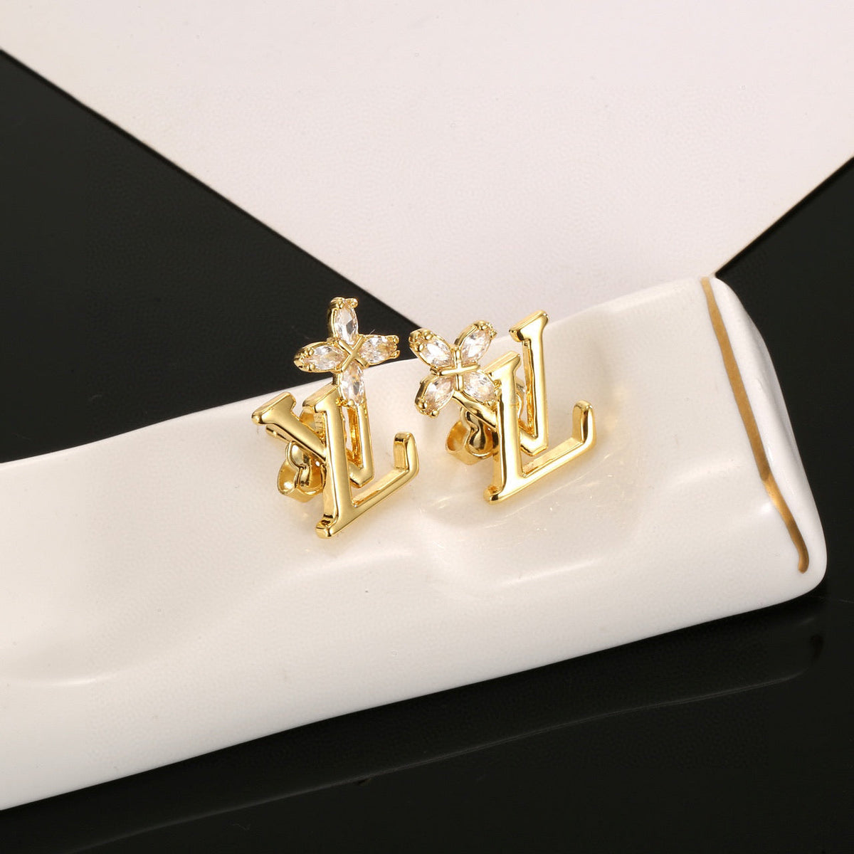 Martin Graham stud earrings in polished metal-tone – styled product view