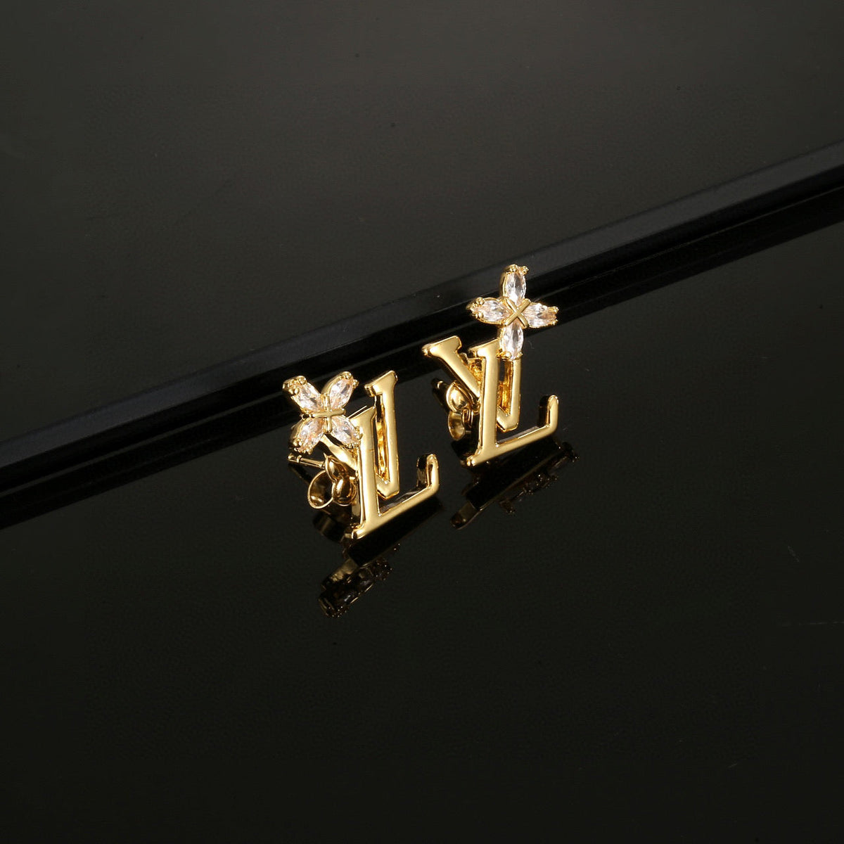 Martin Graham stud earrings in polished metal-tone – front product view