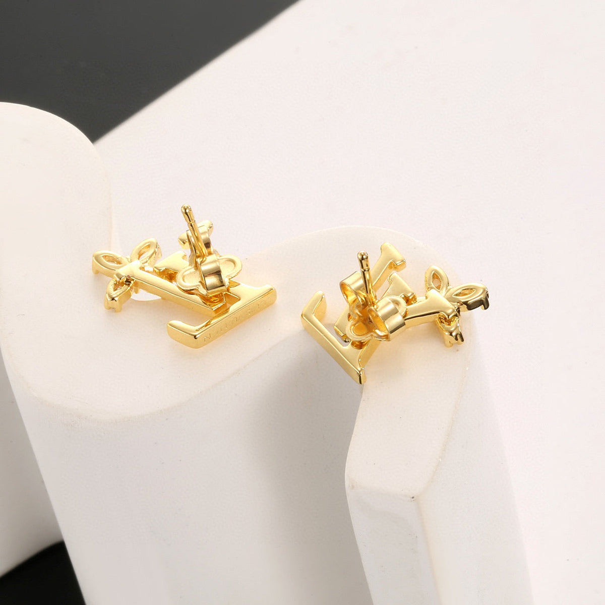 Martin Graham stud earrings in polished metal-tone – close-up detail