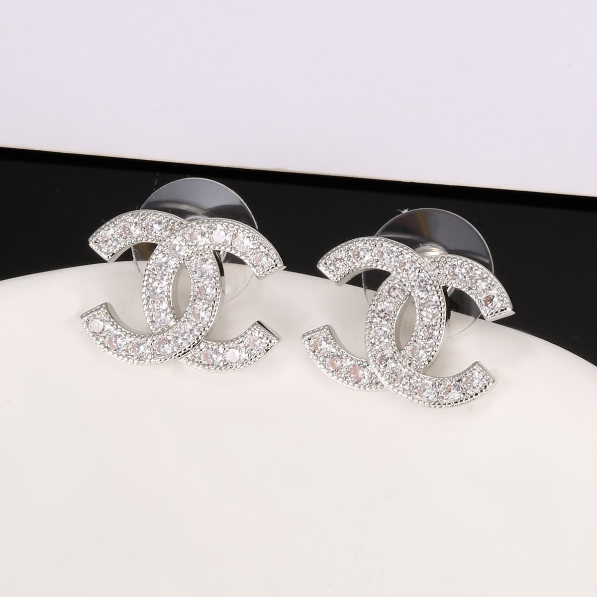 Martin Graham stud earrings in polished metal-tone – close-up detail