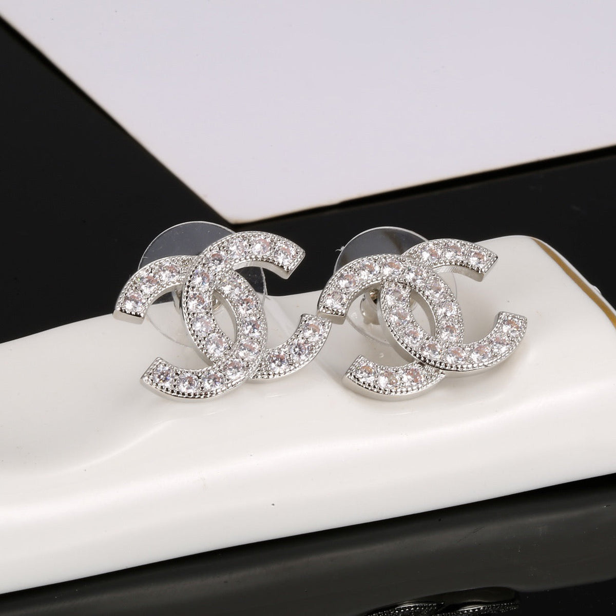 Martin Graham stud earrings in polished metal-tone – side detail