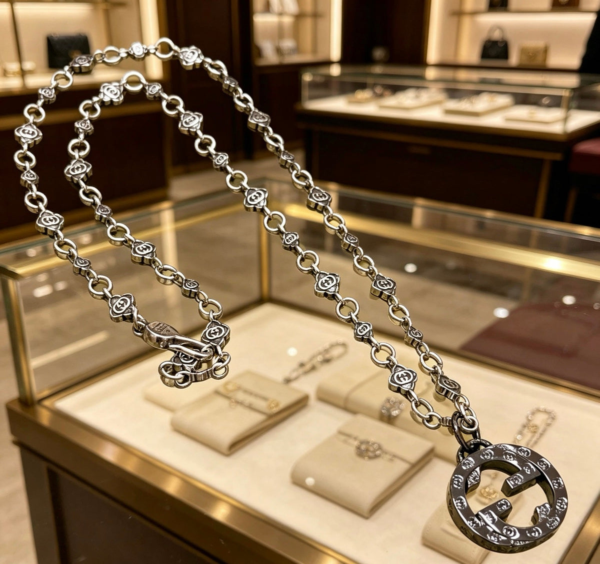 Martin Graham pendant necklace in polished metal-tone – close-up detail