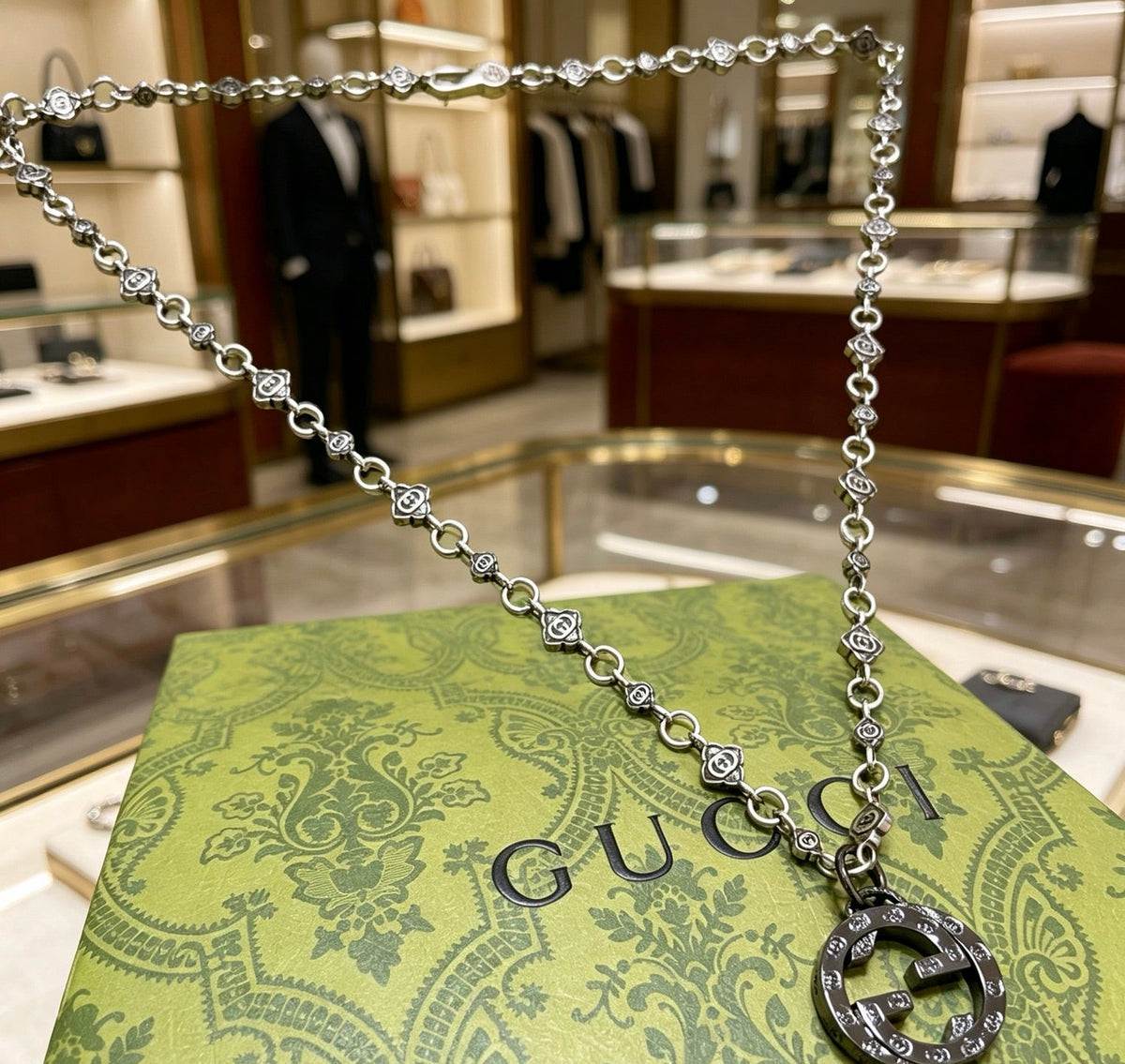 Martin Graham pendant necklace in polished metal-tone – side detail