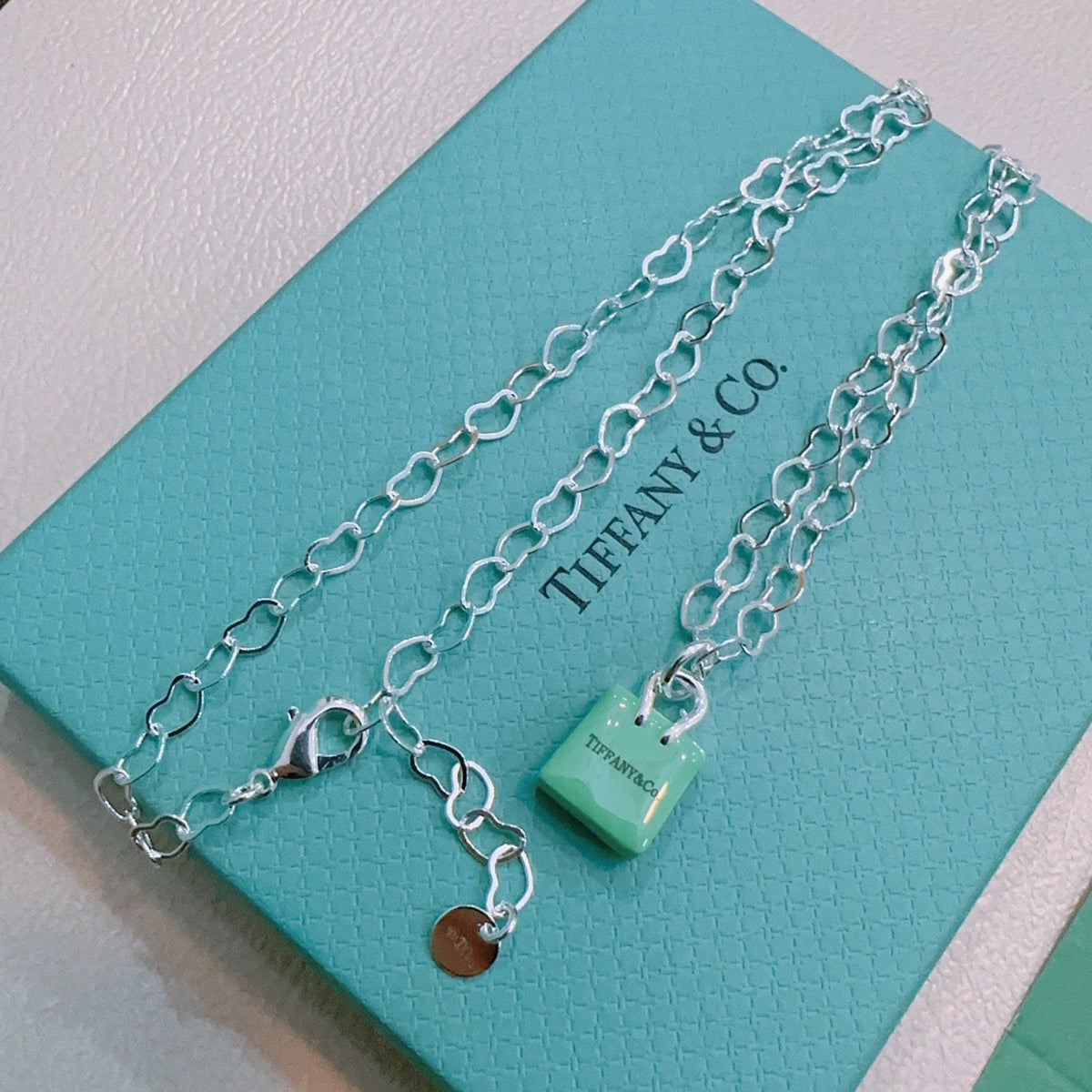Martin Graham pendant necklace in polished metal-tone – close-up detail